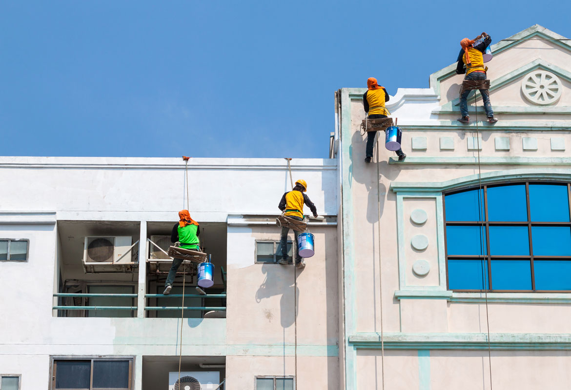 men working painting a building